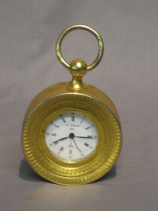 A 20th Century French alarm clock with enamelled dial and Roman Numerals, marked Le Marais Paris and contained in a gilt case 3"
