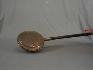 An 18th Century copper warming pan with engraved lid and turned fruit wood handle