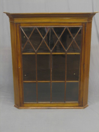 A 19th Century inlaid mahogany corner cabinet with moulded cornice, the interior fitted shelves enclosed by astragal glazed panelled doors 36"