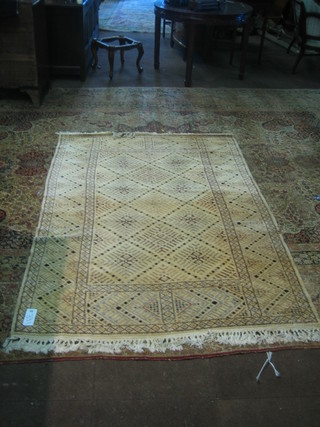An Eastern white ground rug with geometric design to the centre 84" x 58"