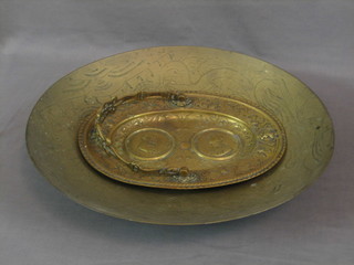 An oval brass dish with swing handle 11" and an Eastern brass bowl 16"