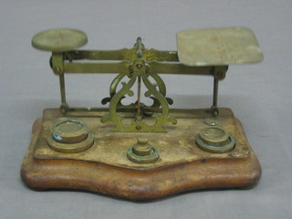 A pair of brass postage scales complete with weights