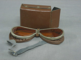 A pair of orange tinted goggles
