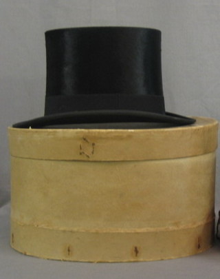 A gentleman's black silk top hat by Henry Heath Ltd, approx. size 7
