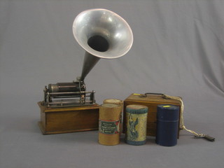 A portable phonograph contained in an oak case 8", together with 21 various cylinders