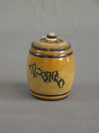 A Doulton tobacco jar decorated a seated monkey with pipe, the reverse marked Tobacco (rim badly restored) 5"