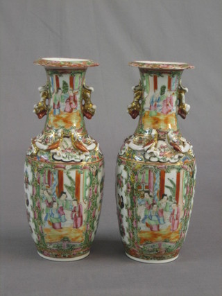 A pair of 19th Century Canton Famille Rose porcelain vases of club form and with mystic dragon handle 10"