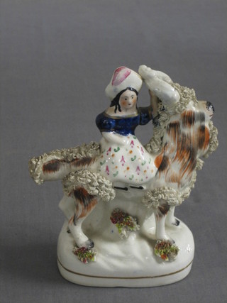 A 19th Century Staffordshire figure group of a girl riding a dog 6"