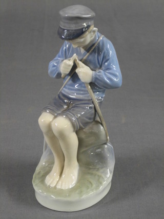 A Royal Copenhagen figure of a fisher boy, the base marked 905 8"