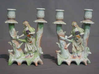 A pair of 19th Century porcelain twin light candelabrum supported by a figure of a lady by a gate (1f) 8"