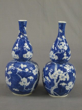 A pair of 19th Century Oriental blue and white prunus pattern double gourd shaped vases, the base with 4 character mark (1 f and r and 1 chip to rim) 10"