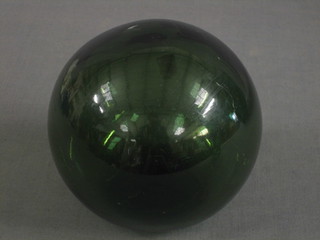 A green glass fishing float, the base marked PCF