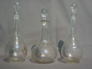 A pair of cut glass club shaped decanters and 1 other