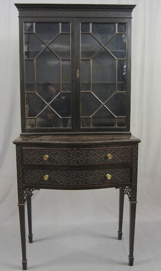 An Edwardian Chippendale style mahogany cabinet on stand, the upper section with moulded cornice and blind fret work frieze, the interior fitted adjustable shelves enclosed by astragal glazed doors, the base fitted 2 long drawers, raised on square turned supports ending in spade feet, with blind carved blind fret work decoration throughout 30"
