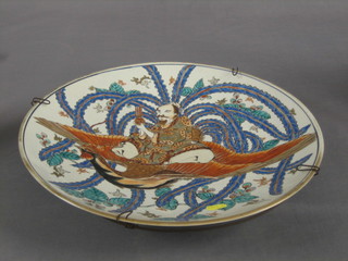 An Oriental porcelain charger decorated a sage 16", the base with signature mark