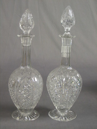 A pair of cut glass mallet shaped decanters