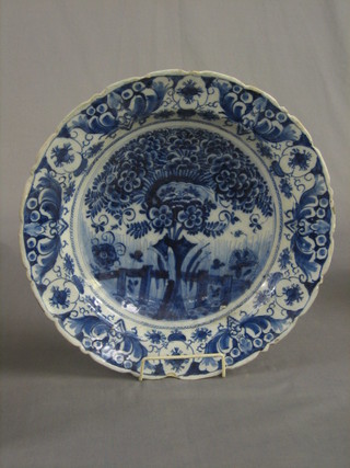 A Delft circular pottery dish decorated a stylised tree, the base marked 490 14"