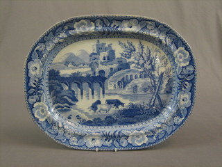 A 19th Century blue and white meat plate decorated watering cattle 21"