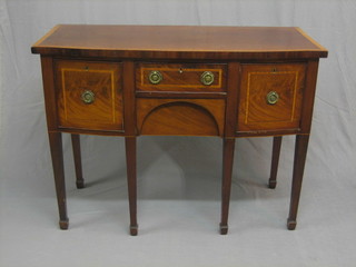 A  Georgian mahogany bow front sideboard with crossbanded and inlaid top, fitted 2 short drawers flanked by a pair of long drawers, raised on square tapering supports ending in spade feet 47"