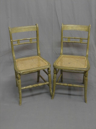A pair of 19th Century painted bar back bedroom chairs with woven cane seats, raised on turned supports