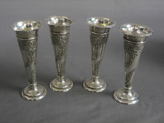 A set of 4 Edwardian embossed silver trumpet shaped specimen vases, raised on circular spreading feet, London 1902, 7",