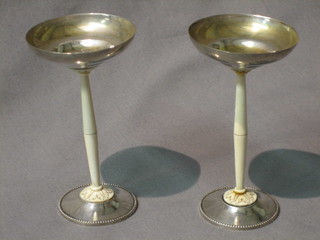 A pair of 1930's Continental silver and ivory pedestal salts raised on turned ivory columns, 5"