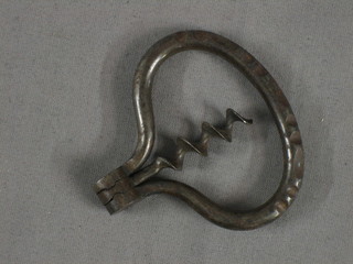 A 19th Century polished steel travelling folding corkscrew with oval handle 4" overall