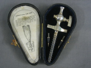 A champagne spigot, contained in a leather box