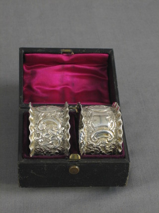 A pair of Victorian embossed silver napkin rings, cased