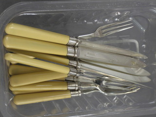 A set of 6 silver plated fruit knives and forks