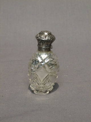 An Edwardian glass scent bottle with embossed "silver" lid  3"