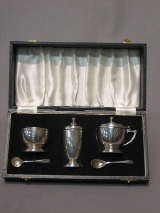 A silver 3 piece condiment set comprising mustard pot, pepper pot and salt Birmingham 1970, cased