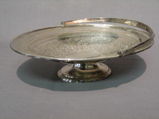 An oval silver plated cake basket with swing handle