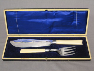 A pair of silver plated fish servers, cased