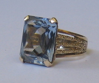 A 9ct gold dress ring set a rectangular cut aquamarine
