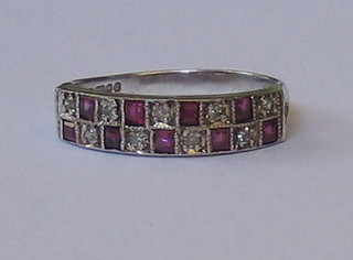 A lady's 18ct white gold half eternity ring set rubies and diamonds