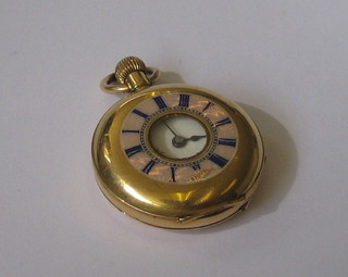 A lady's fob watch contained in a 14ct gold demi-hunter case