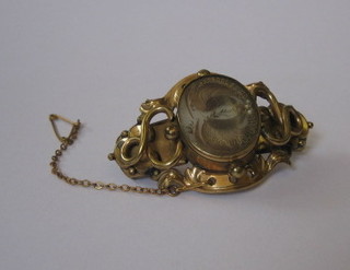 A 19th Century gilt metal mourning brooch with hair sculpture
