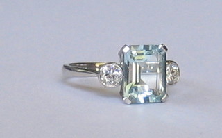 A lady's 18ct white gold dress ring set a rectangular cut aquamarine supported by 2 diamonds (approx 0.42/2.80ct)