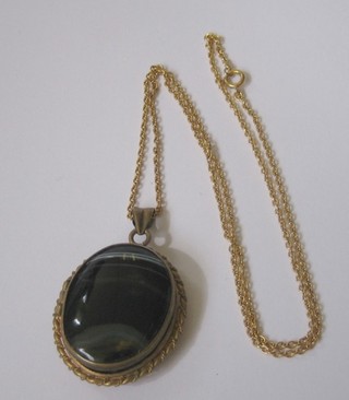 A Victorian hardstone and micromosaic oval locket contained in a gilt metal mount on a gilt chain