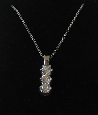 A lady's 3 stone diamond pendant, hung on a fine gold chain (approx 0.75ct)