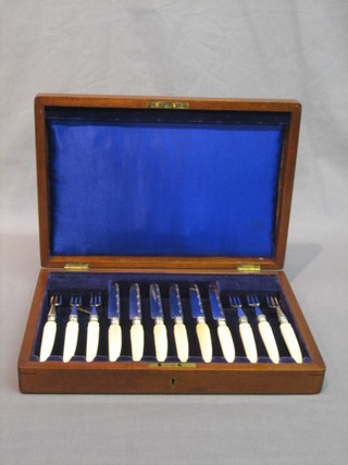 A canteen of 6 19th Century silver plated fruit knives with ivory handles, contained in a walnut canteen box