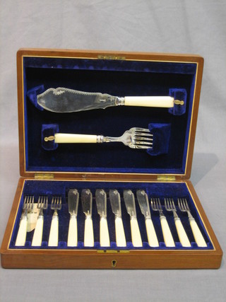 A set of 6 silver plated fish knives and forks complete with servers contained in a walnut canteen box