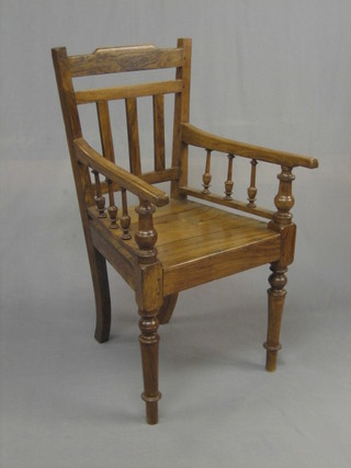 A hardwood stick and bar back carver chair with bobbin turned decoration, raised on turned supports