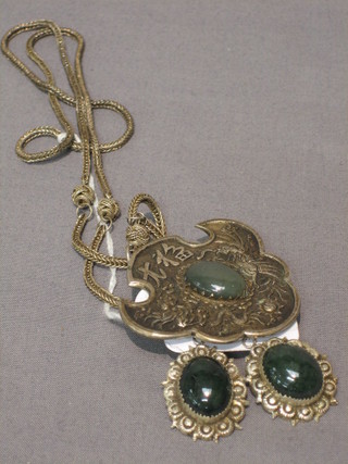 An Eastern green and metal suite of jewellery comprising earrings and pendant