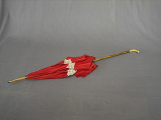 An Edwardian red silk parasol