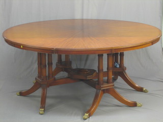 A Georgian style circular mahogany pedestal dining table, raised on 4 turned columns with X framed stretcher 73"