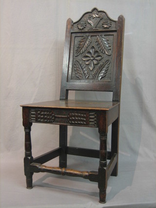 A Victorian oak hall chair with crest to the back carved a harp