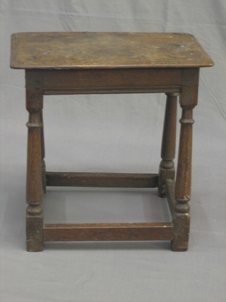 A 17th/18th Century rectangular oak joyned stool, raised on turned and block supports, the top and seat signed B E E, 19" (top cracked and filled)