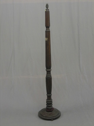 A mahogany turned and reeded standard lamp